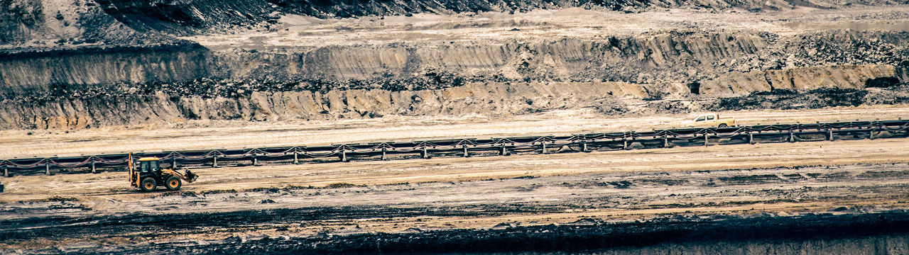 Aerial view of an open-pit mine with excavator